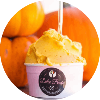A cup of ice cream with pumpkins